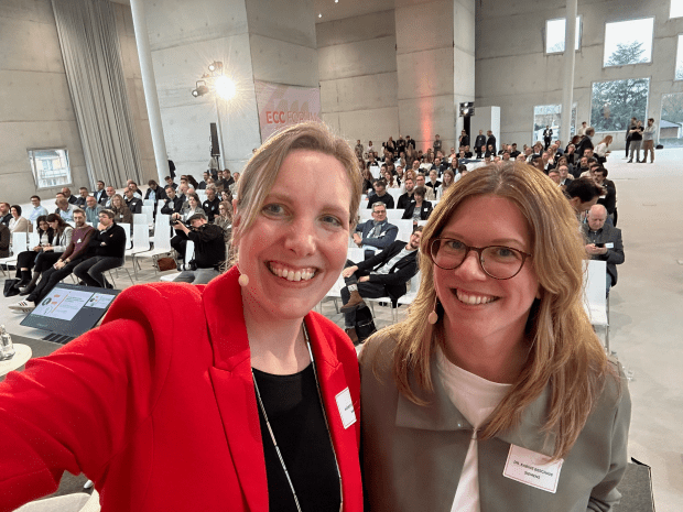 Agnes Bührmann and Sabine Berghaus snap a selfie on stage in front of the audience at ECC Forum in Essen. 